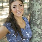 Photo of a girl Shoshana Pritzker standing near a tree.